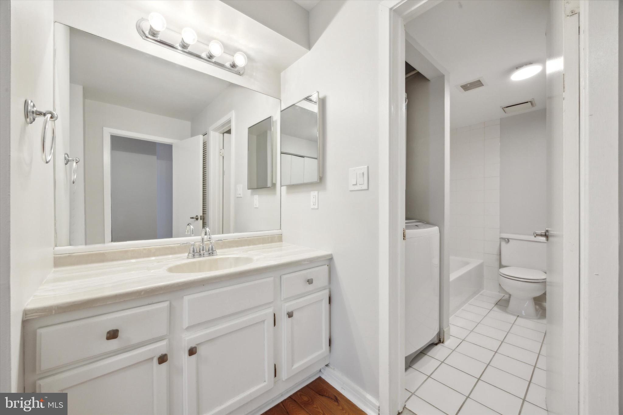 222 Church Street, Unit 3F Philadelphia, PA 19106 - Photo 16 of 19 a spacious bathroom with a granite countertop sink mirror and toilet