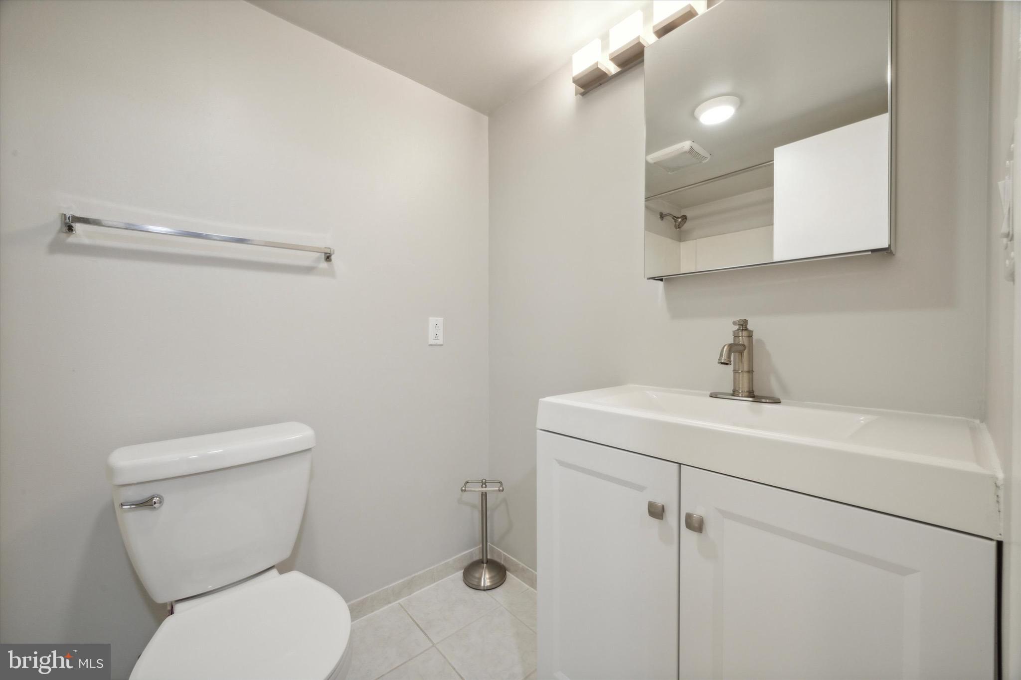 222 Church Street, Unit 3F Philadelphia, PA 19106 - Photo 10 of 19 a bathroom with a toilet sink and mirror