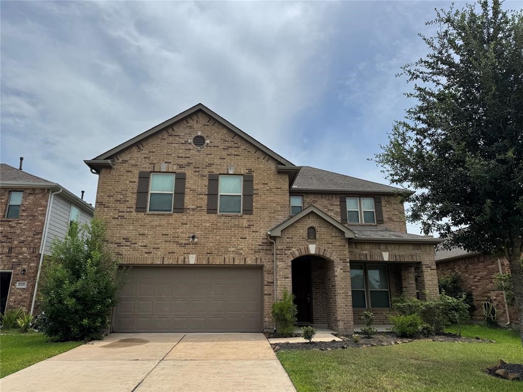 2818 Mezzomonte Lane League City, TX 77573 - Photo 1 of 13 a front view of a house with a garden