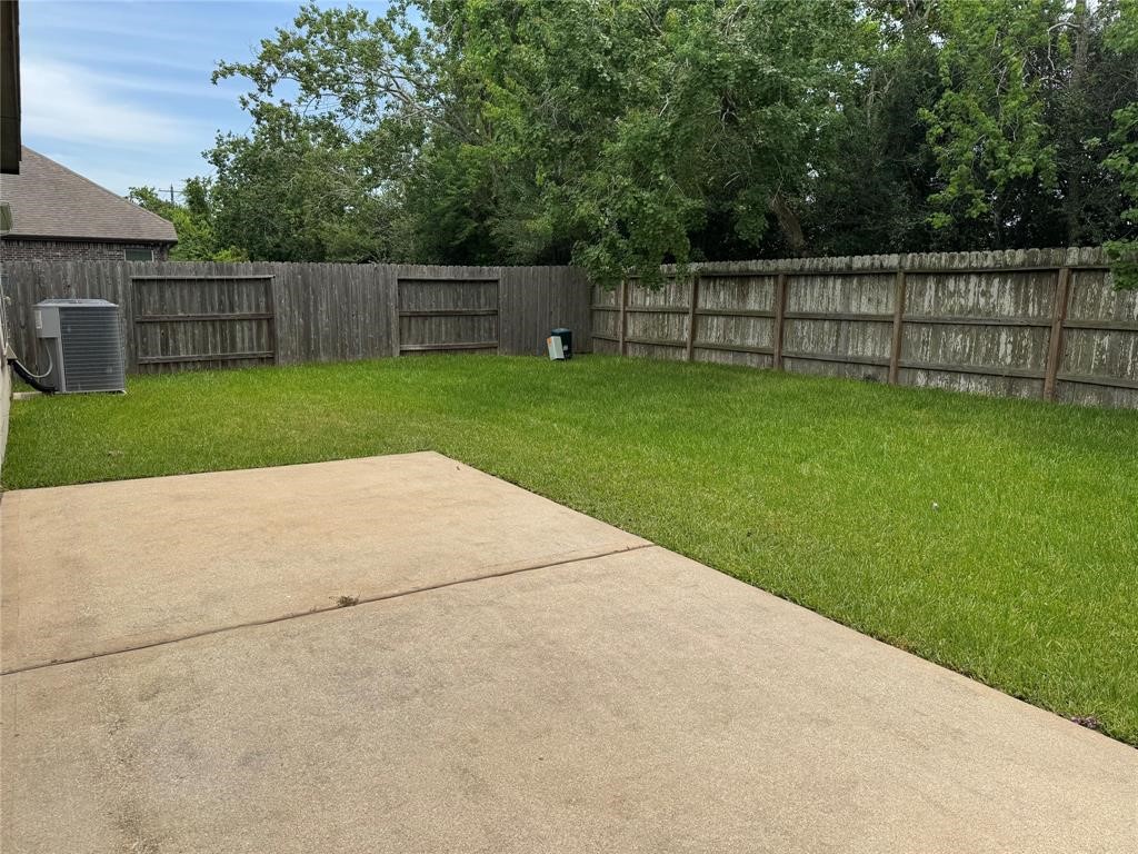 2818 Mezzomonte Lane League City, TX 77573 - Photo 12 of 13 a view of a backyard with a small cabin