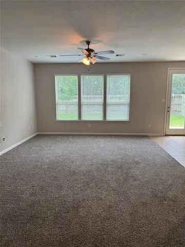 a view of room with window and ceiling fan