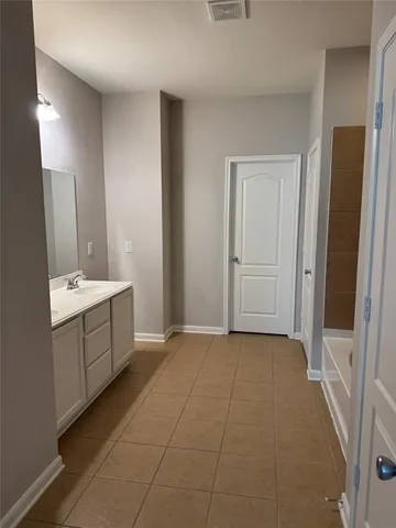 a bathroom with a sink a mirror and a vanity