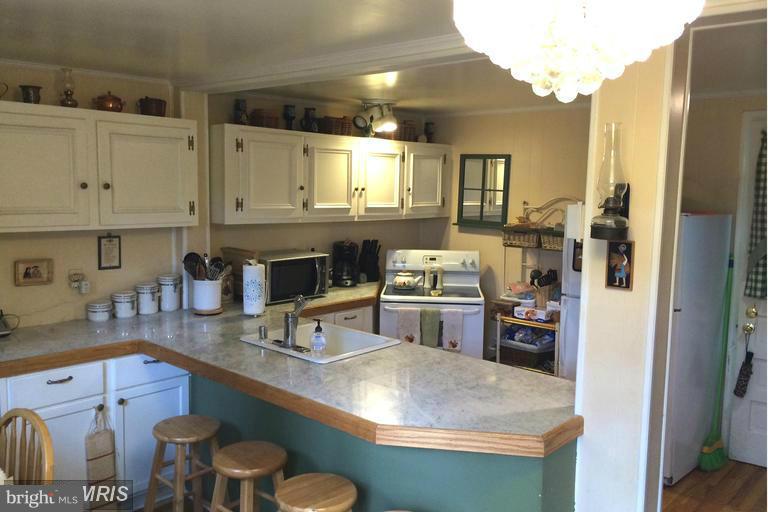 1868 Garrett Road Manchester, MD 21102 - Photo 3 of 20 a kitchen with stainless steel appliances granite countertop a sink stove and refrigerator
