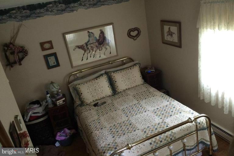 1868 Garrett Road Manchester, MD 21102 - Photo 6 of 20 a bed sitting in a bedroom next to a window