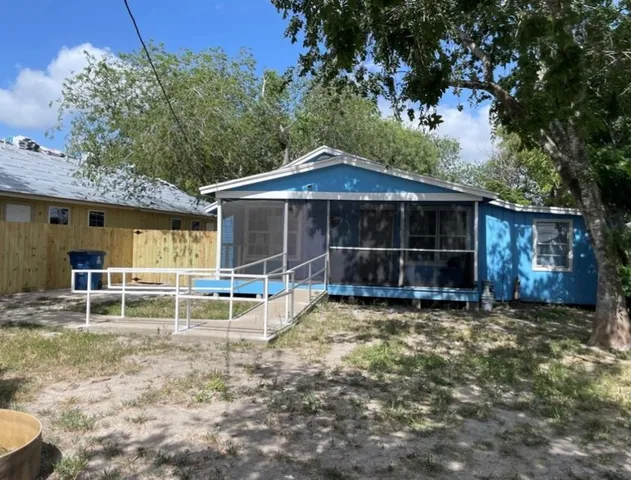 a view of a house with a yard and sitting area