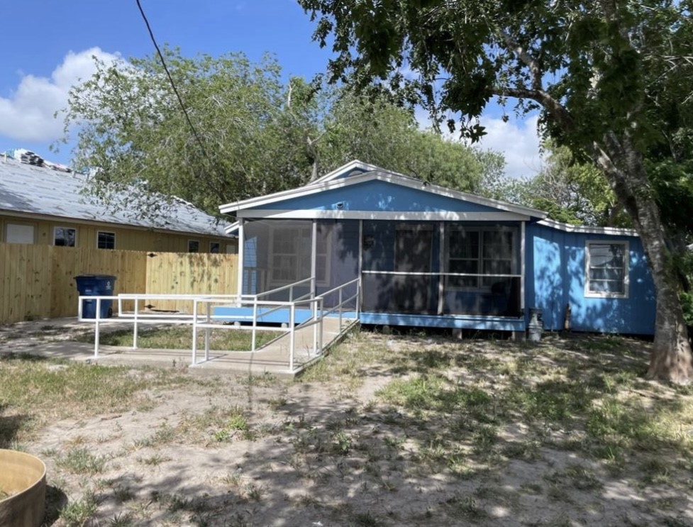 a view of a house with a yard and sitting area