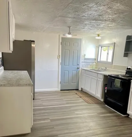 a kitchen with a sink and a stove top oven