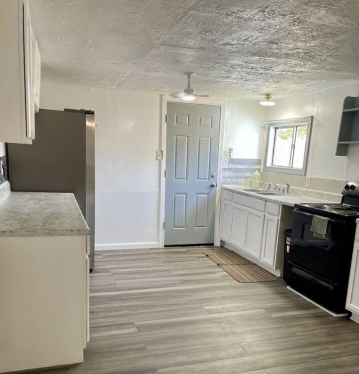 516 Sodville Street Sinton, TX 78387 - Photo 3 of 11 a kitchen with a sink and a stove top oven