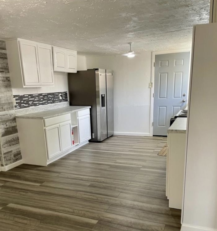 516 Sodville Street Sinton, TX 78387 - Photo 4 of 11 a kitchen with a cabinets and wooden floor