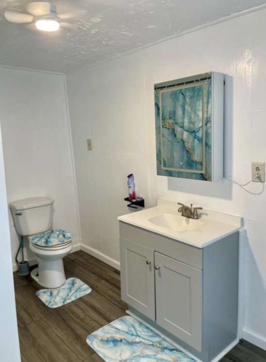 516 Sodville Street Sinton, TX 78387 - Photo 6 of 11 a bathroom with a toilet a sink a mirror and vanity