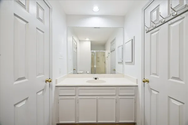 a bathroom with a sink vanity and a mirror