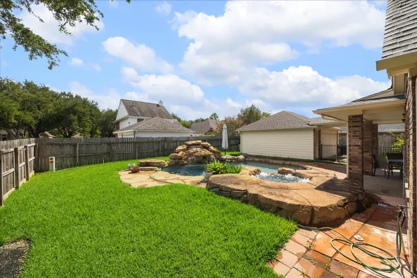 a view of a backyard with sitting area