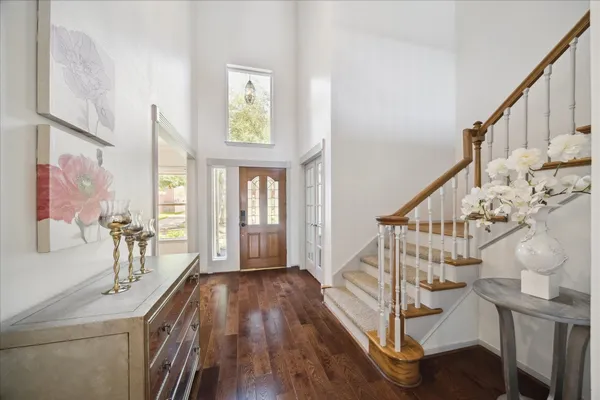 a view of entryway with wooden floor and windows