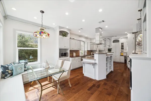 a living room with kitchen island furniture and a chandelier