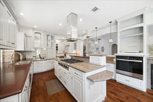 a kitchen with stainless steel appliances granite countertop a sink stove and refrigerator
