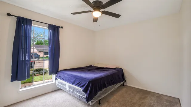 a spacious bedroom with a bed and a chandelier