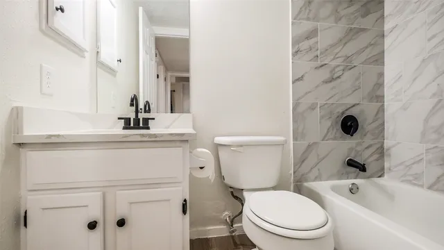 a white toilet sitting next to a bathroom sink