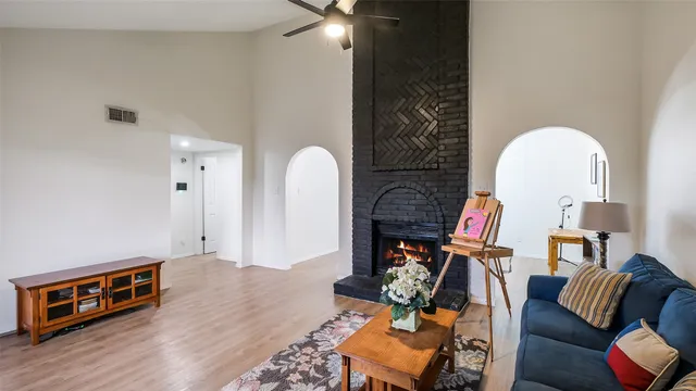 a living room with furniture a flat screen tv and a fireplace