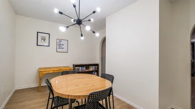 a view of a room with a table and chairs
