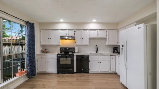 a kitchen with stainless steel appliances a refrigerator stove and sink