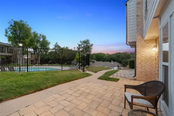 a view of a backyard with sitting area