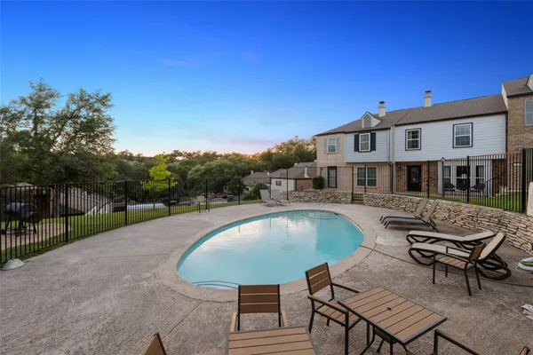 a swimming pool with outdoor seating and yard