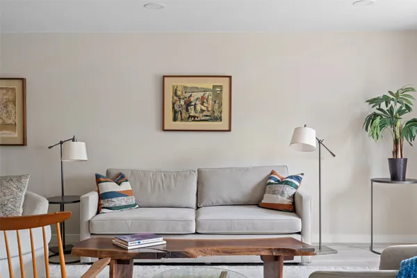 a living room with furniture and a lamp