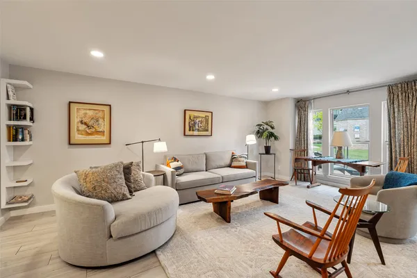 a living room with furniture and a potted plant