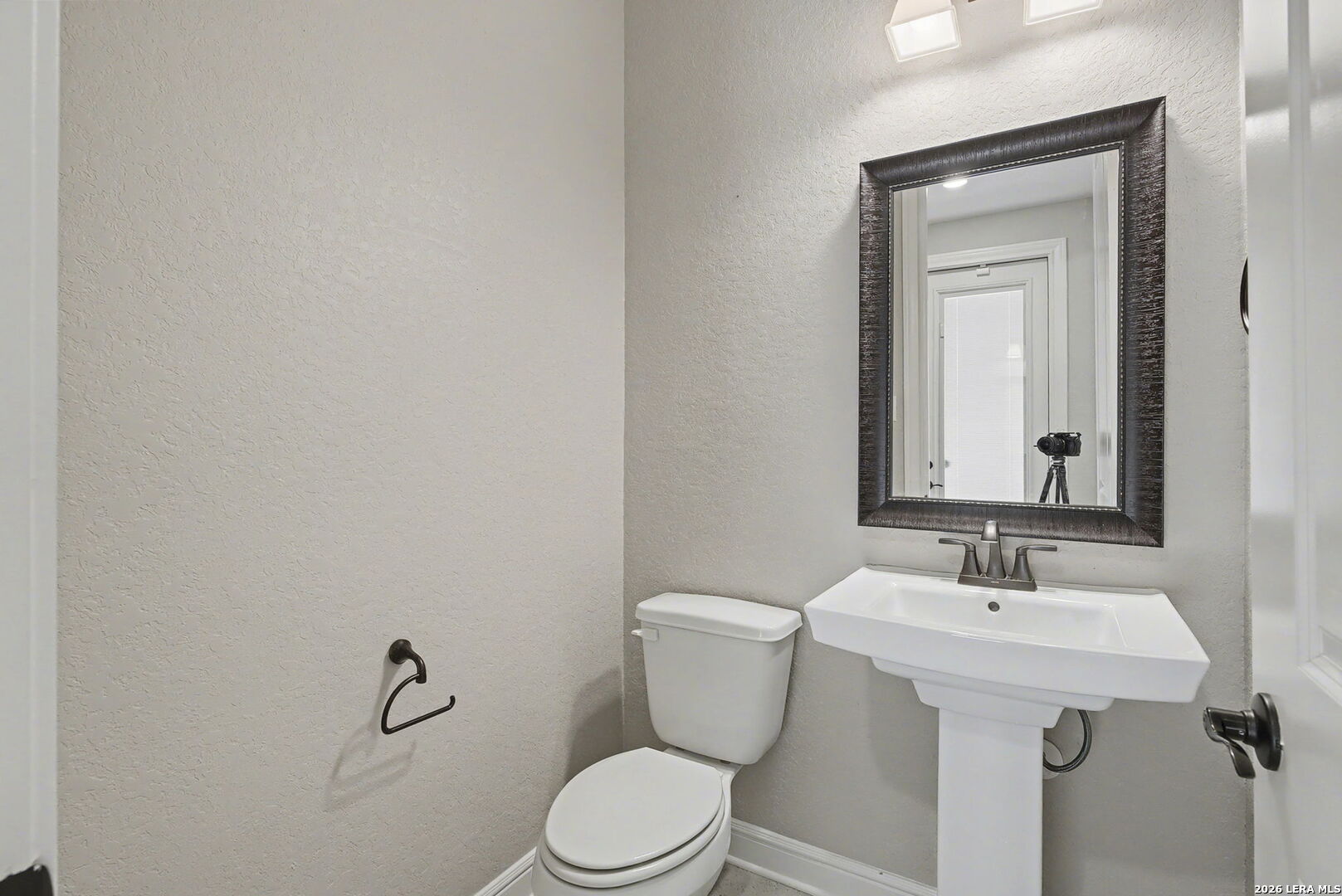 269 Big Bend Path Castroville, TX 78009 - Photo 19 of 42 a bathroom with a toilet sink and mirror