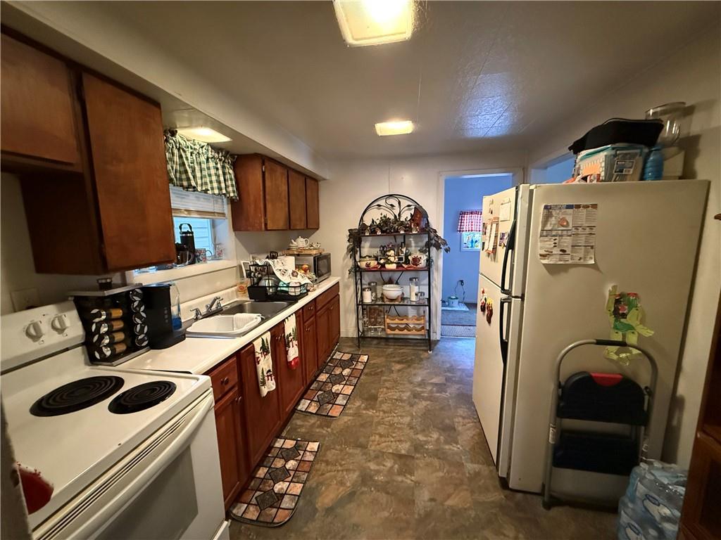420 Negley Avenue Butler, PA 16001 - Photo 12 of 15 a kitchen with stainless steel appliances a stove a refrigerator a sink a stove and wooden floors