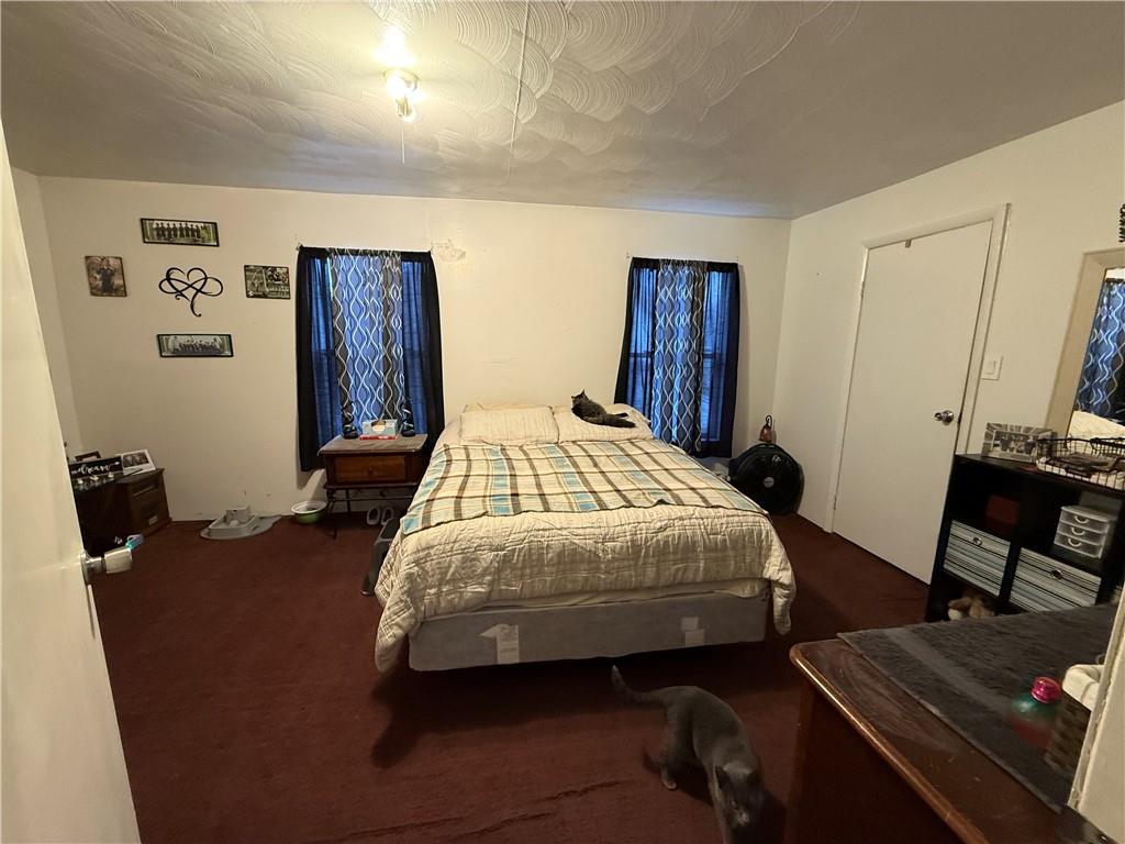 420 Negley Avenue Butler, PA 16001 - Photo 6 of 15 a bedroom with a bed and wooden floor