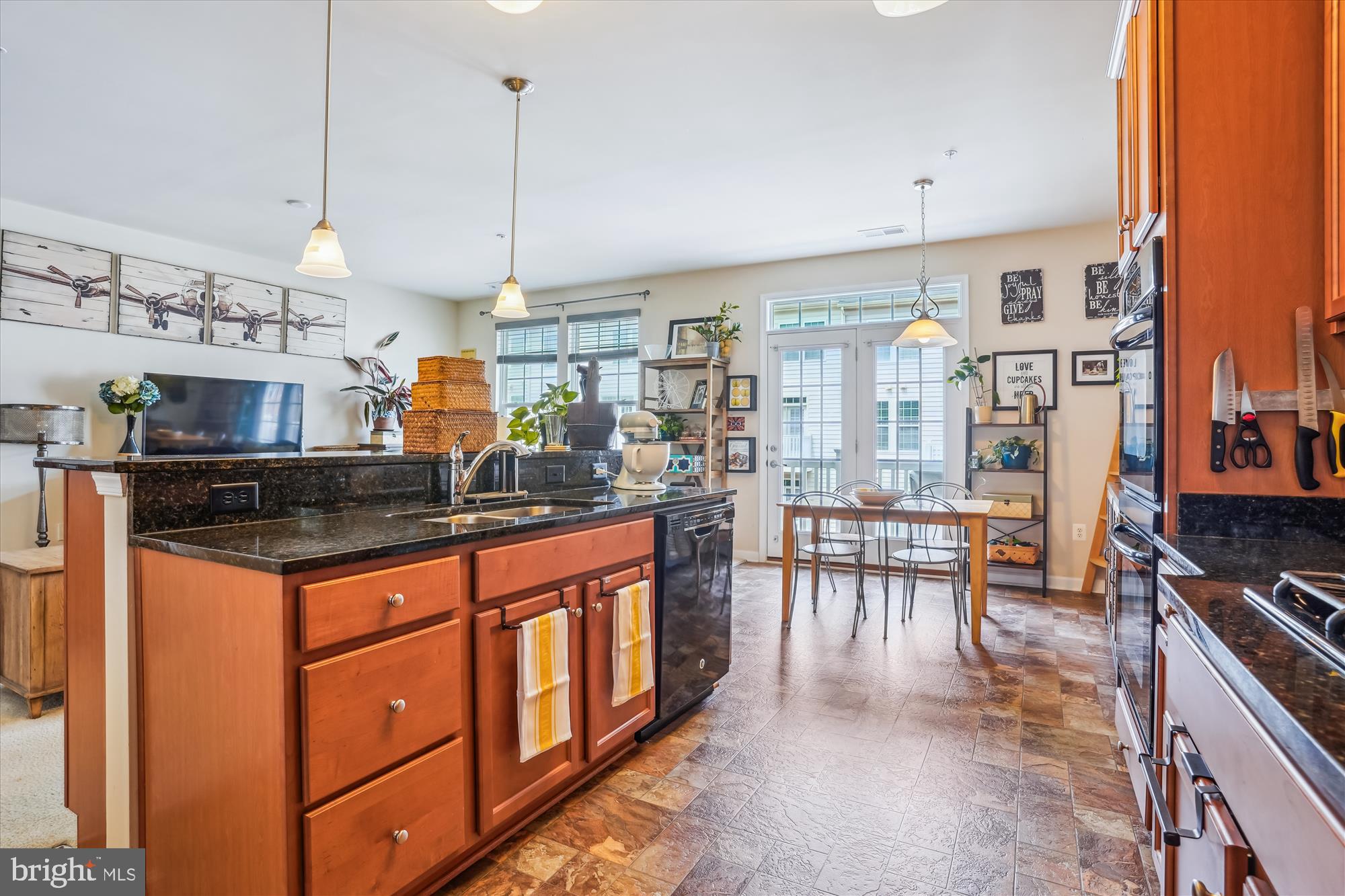 910 Hall Station Drive, Unit 202 Bowie, MD 20721 - Photo 11 of 44 a kitchen with stainless steel appliances granite countertop a stove and a view of living room