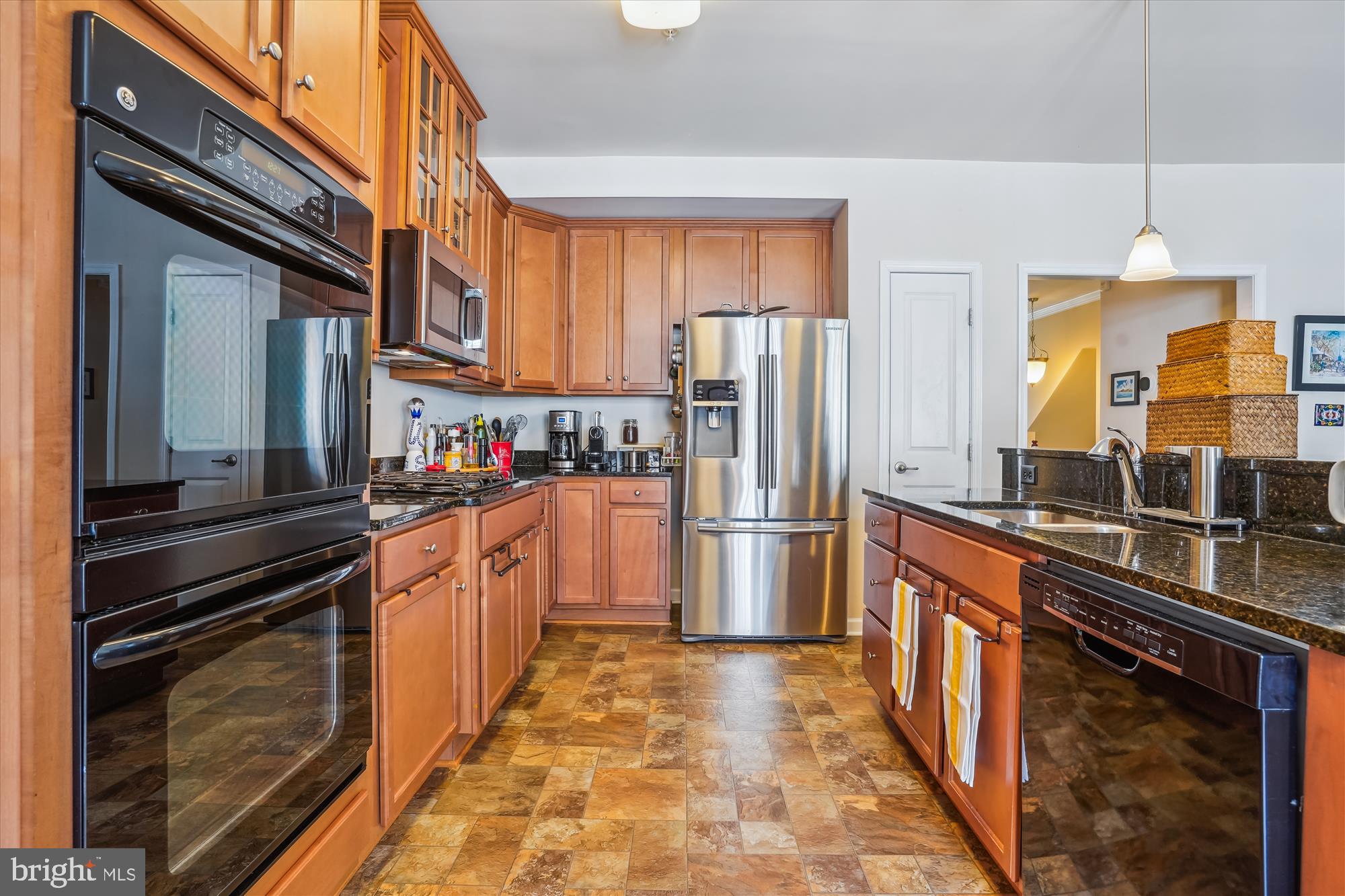 910 Hall Station Drive, Unit 202 Bowie, MD 20721 - Photo 15 of 44 a kitchen with stainless steel appliances granite countertop a refrigerator a stove and a sink