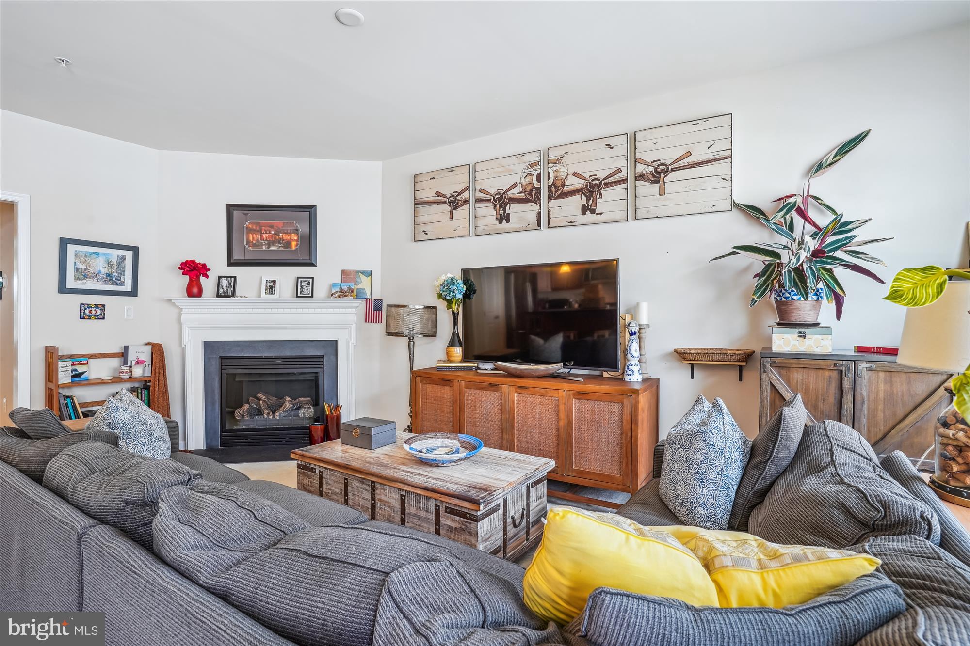 910 Hall Station Drive, Unit 202 Bowie, MD 20721 - Photo 19 of 44 a living room with furniture a flat screen tv and a fireplace