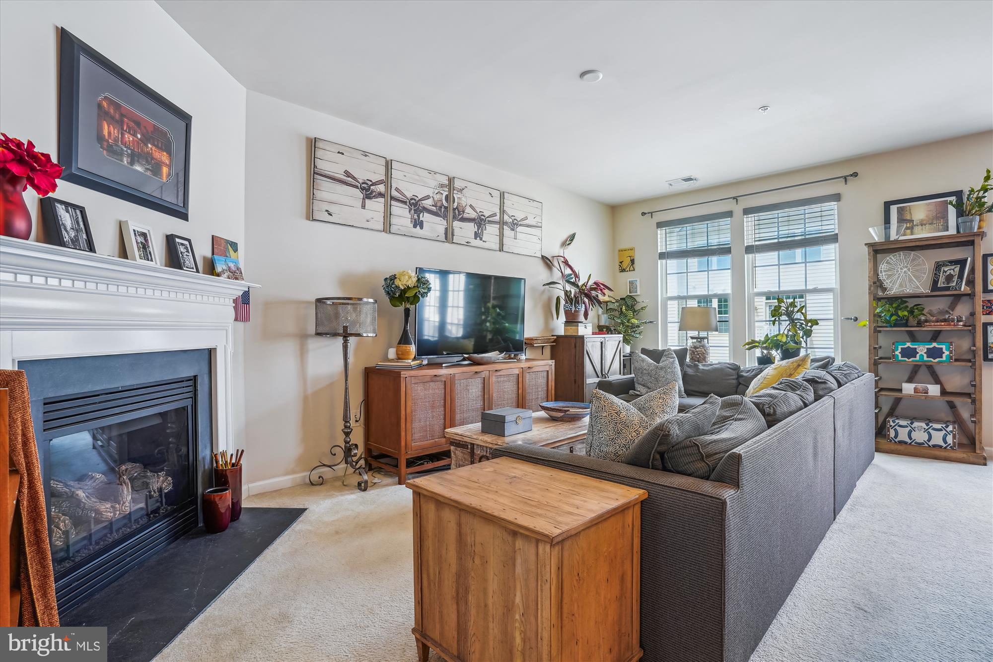 910 Hall Station Drive, Unit 202 Bowie, MD 20721 - Photo 20 of 44 a living room with furniture a fireplace and a window