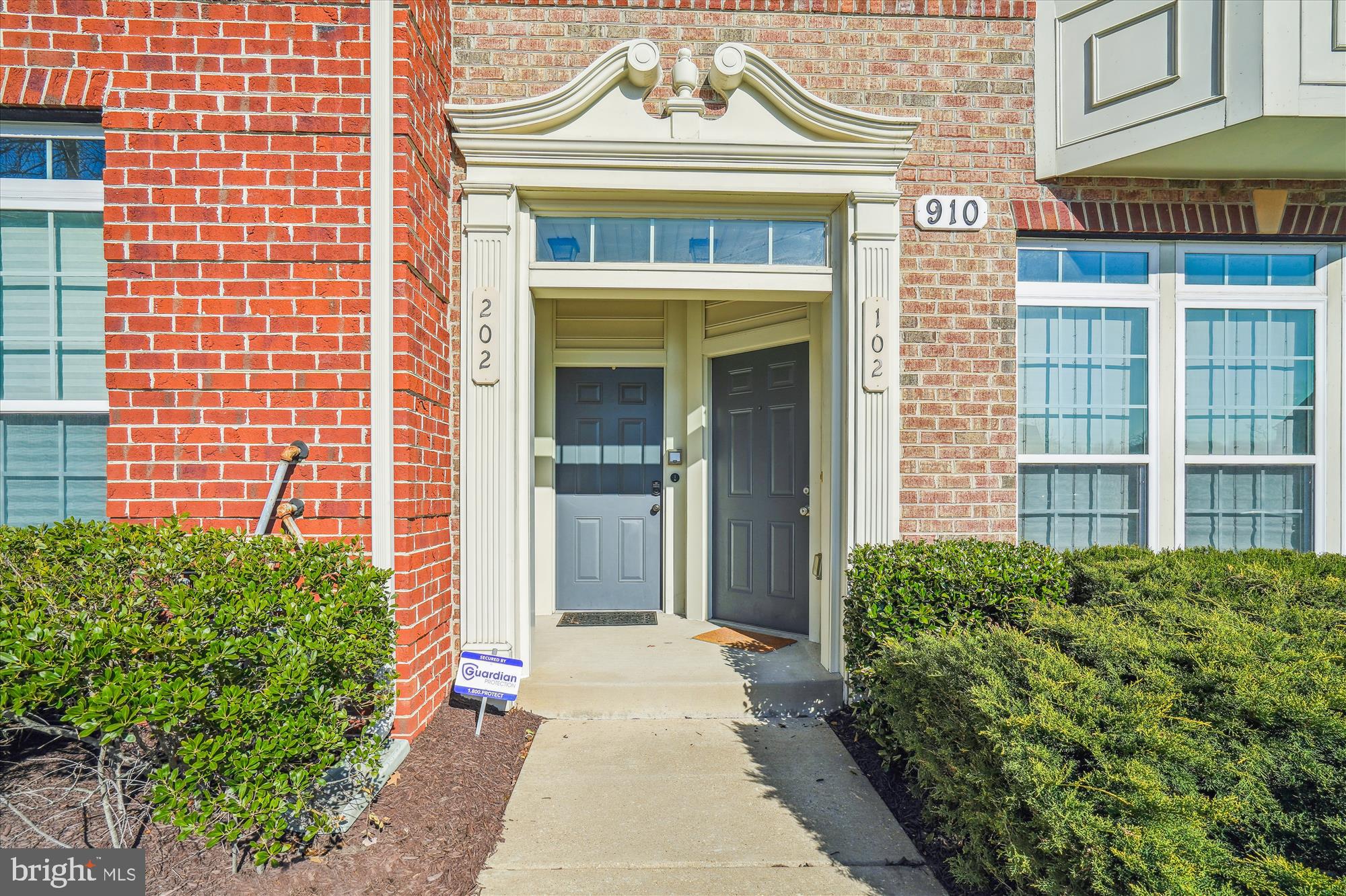 910 Hall Station Drive, Unit 202 Bowie, MD 20721 - Photo 2 of 44 a view of a brick house with plants