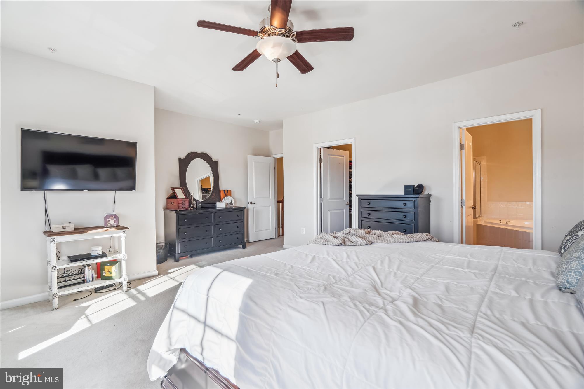 910 Hall Station Drive, Unit 202 Bowie, MD 20721 - Photo 24 of 44 a bedroom with a bed and a flat tv screen on dresser