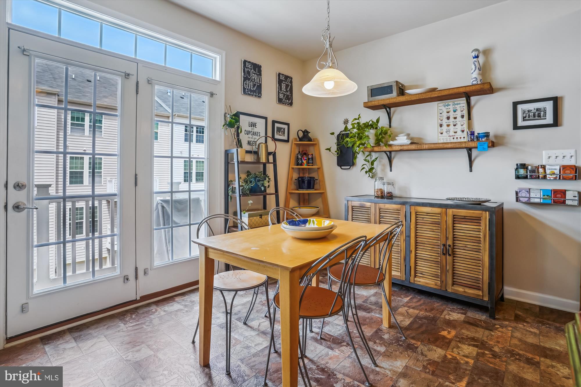 910 Hall Station Drive, Unit 202 Bowie, MD 20721 - Photo 37 of 44 a kitchen that has a table and chairs in it