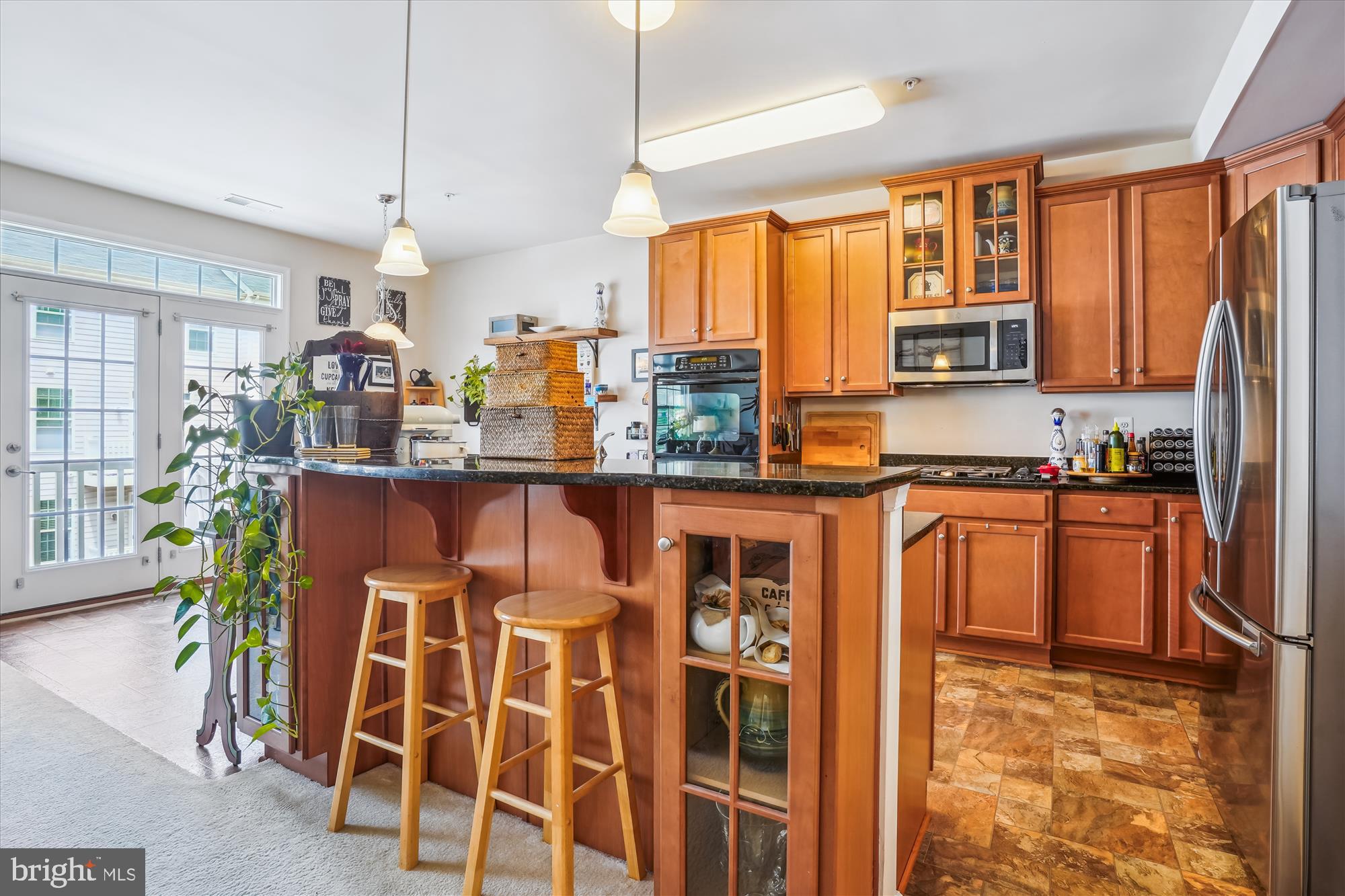 910 Hall Station Drive, Unit 202 Bowie, MD 20721 - Photo 10 of 44 a kitchen with stainless steel appliances granite countertop a stove a sink and a refrigerator