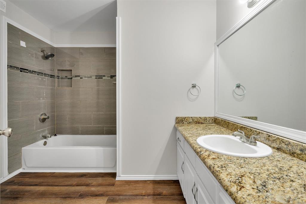 209 Mistletoe Lane Keene, TX 76059 - Photo 33 of 38 a bathroom with a granite countertop sink and a mirror