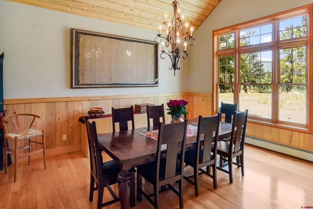 a dining room with furniture window and wooden floor