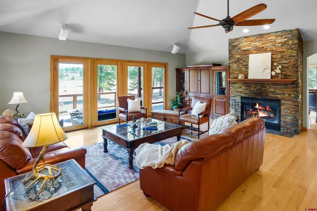 a living room with furniture fireplace and a large window