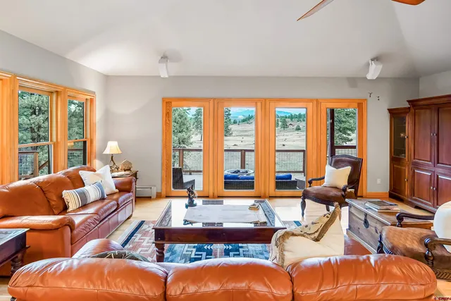 a living room with furniture and floor to ceiling windows