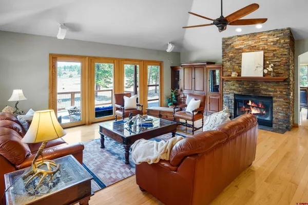 a living room with furniture fireplace and a large window