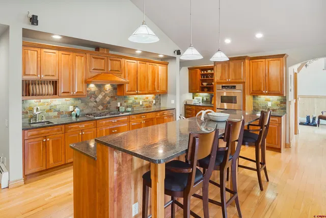 a dining table with chairs and window