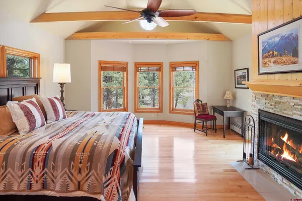 a spacious bedroom with a bed a couch and a chandelier