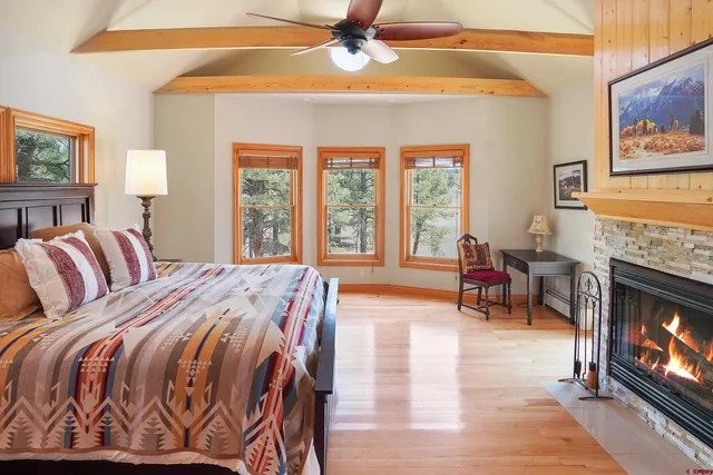 a spacious bedroom with a bed a couch and a chandelier