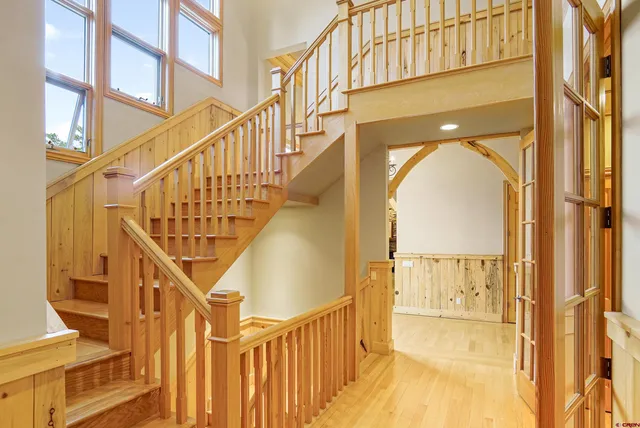 a view of entryway and hall with wooden floor