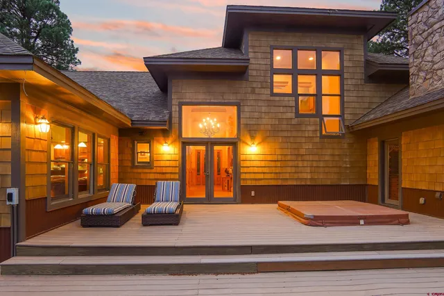 a view of a brick house with large windows