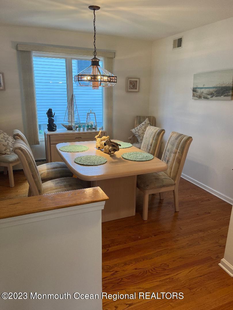 64 Van Ness Drive Brick, NJ 08723 - Photo 13 of 25 a dining room with furniture a chandelier a rug and a chandelier